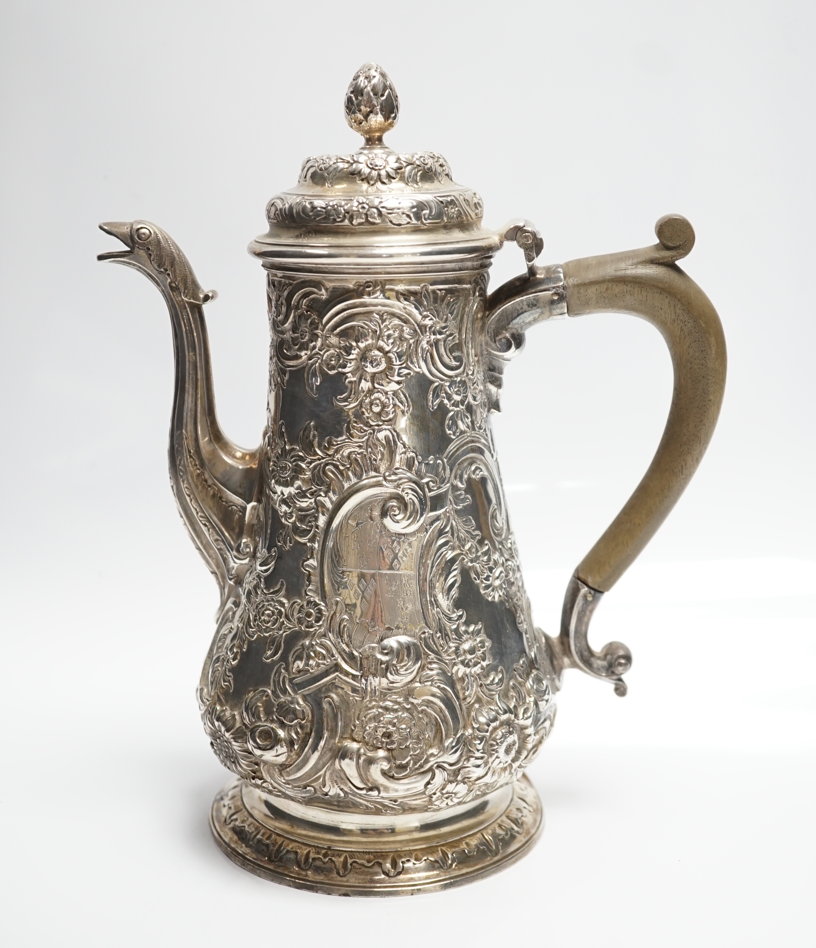 A George II silver baluster coffee pot, with later embossed decoration, maker, ?W, London, 1751, height 25.5cm, gross weight 31.3oz.